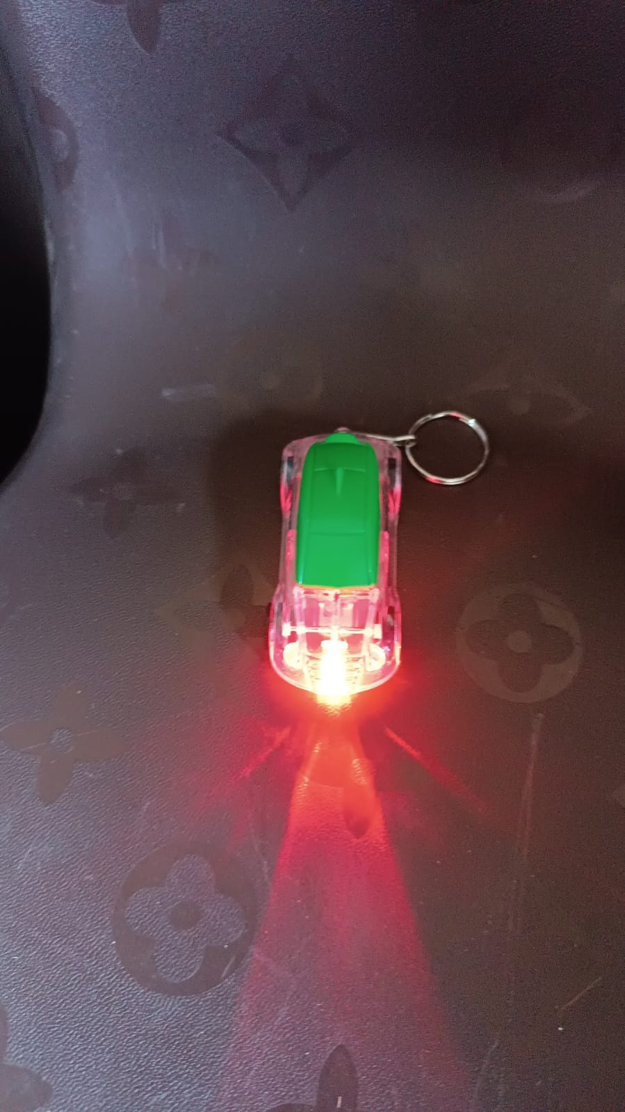 Person holding Mini Car LED Keychain Light to show compact size