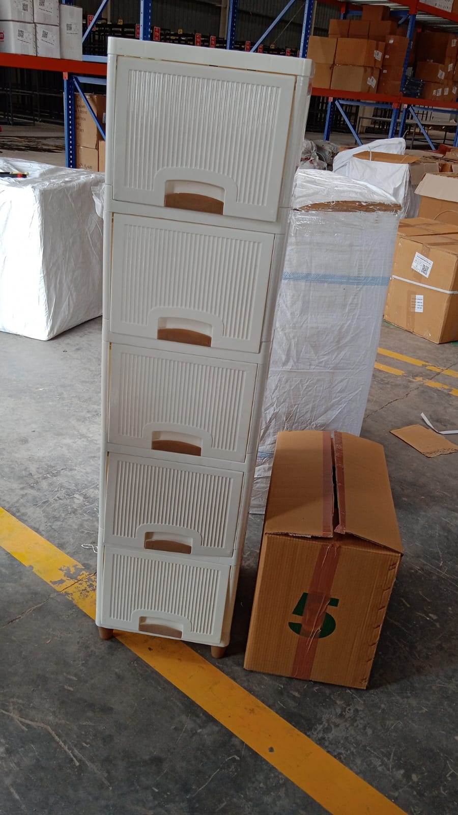 Plastic storage drawer cabinet placed in a home office setting for stationery storage