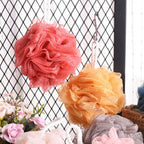 Soft round bath loofah for gentle body scrubbing.