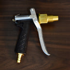 Close-up of the durable metal gold hose nozzle with adjustable spray head.