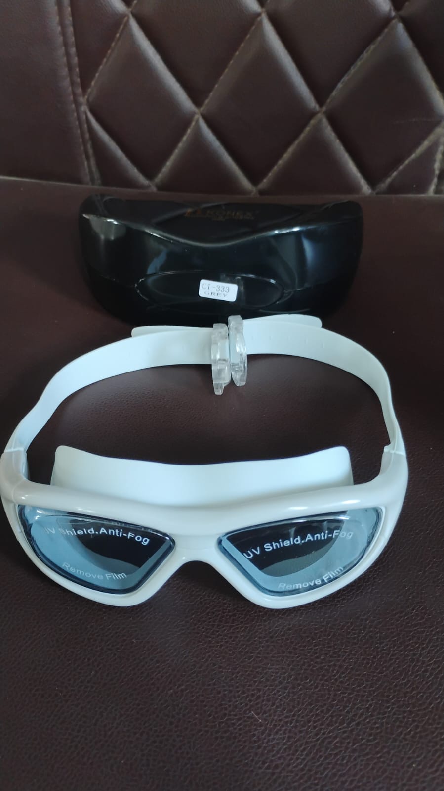 Wide vision swimming goggles displayed on white background with packaging