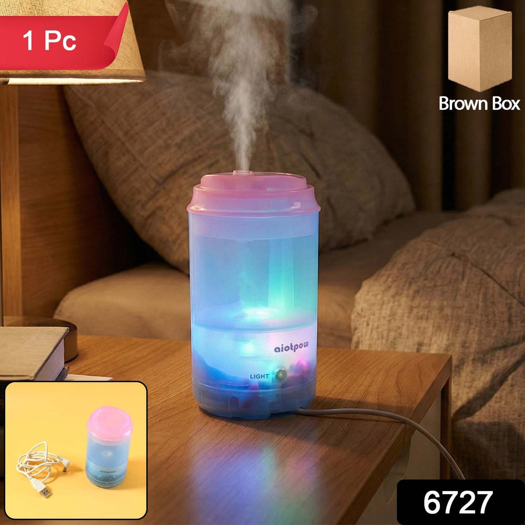 Compact USB essential oil diffuser on an office desk next to a laptop.