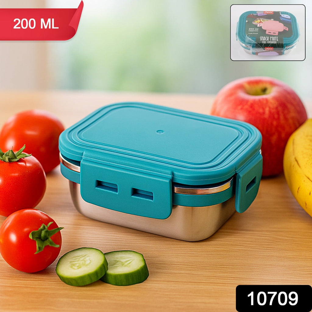 Open stainless steel mini food container filled with berries and nuts