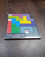 The Inventive Play Wooden Daily Calendar Puzzle in its packaging, suitable as an educational gift.