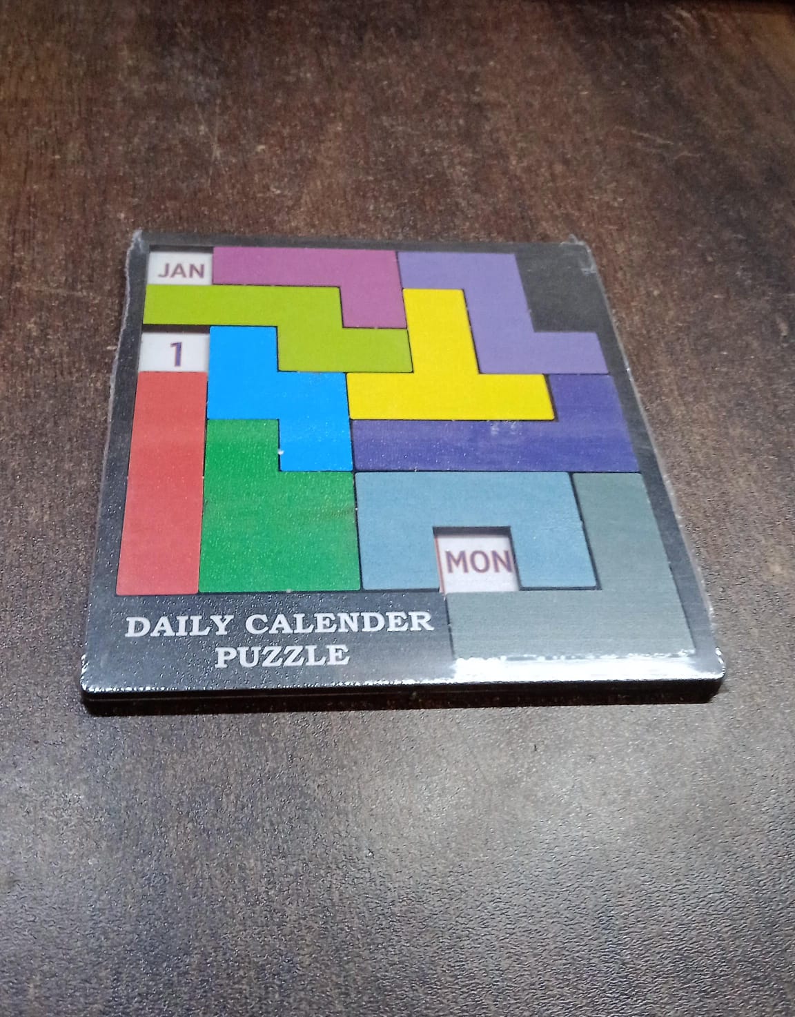 The Inventive Play Wooden Daily Calendar Puzzle in its packaging, suitable as an educational gift.