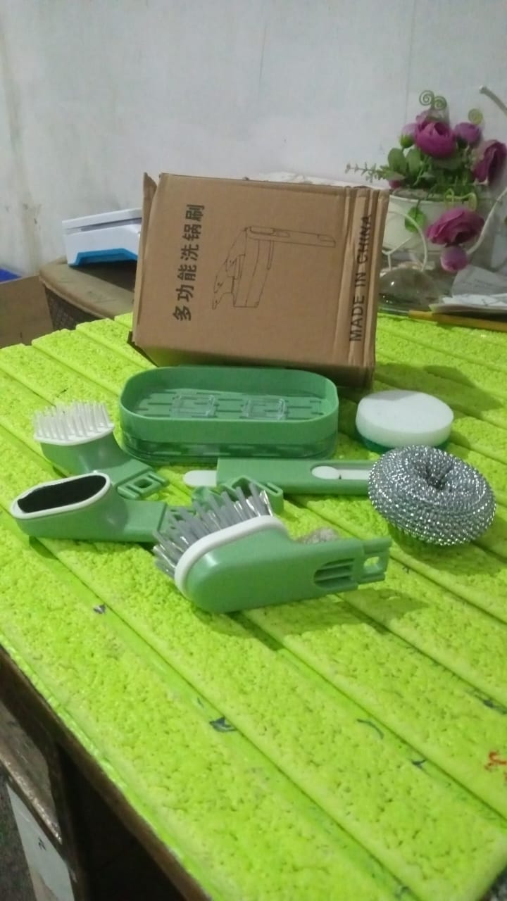 Detailed shot of the long-handled dish cleaning brush, emphasizing its ergonomic design and included replacement heads.