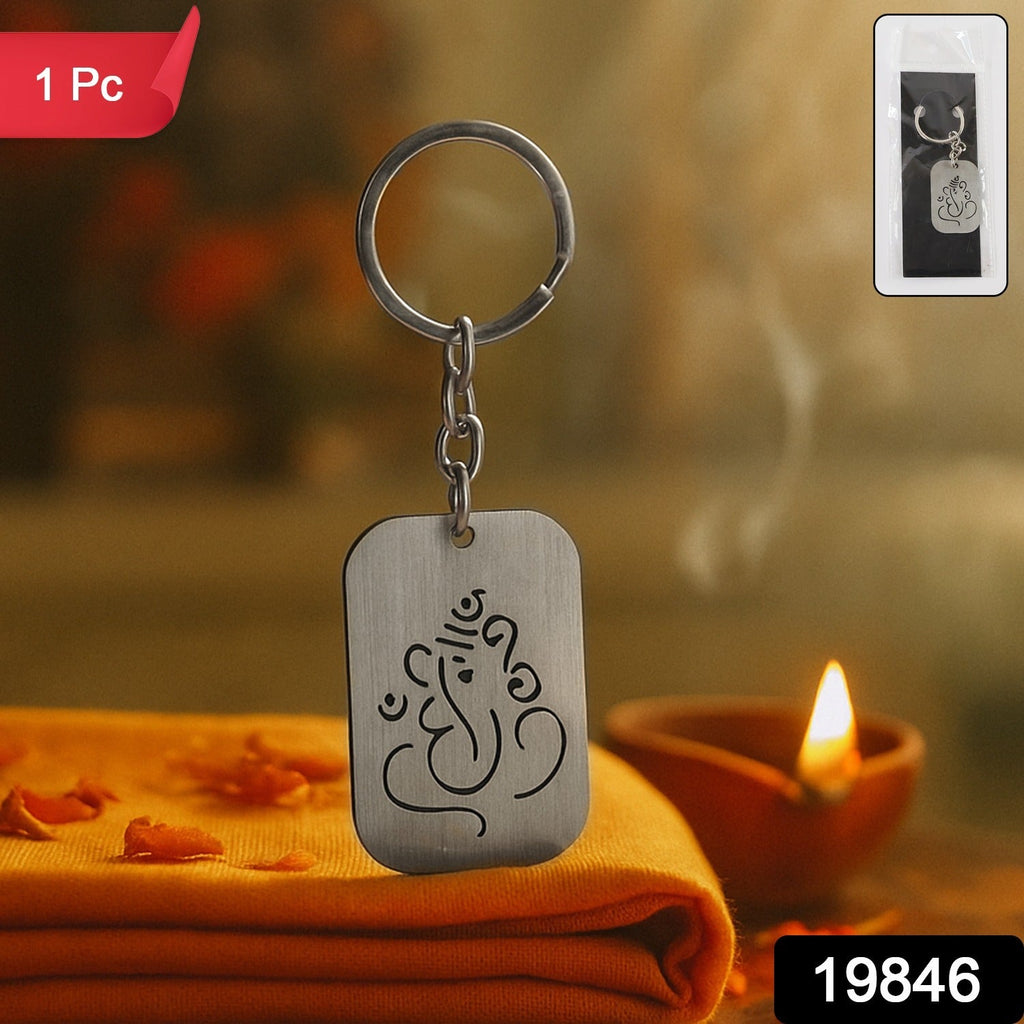 Hand holding a Ganesh Metal Keychain, showcasing its elegant design and finish.