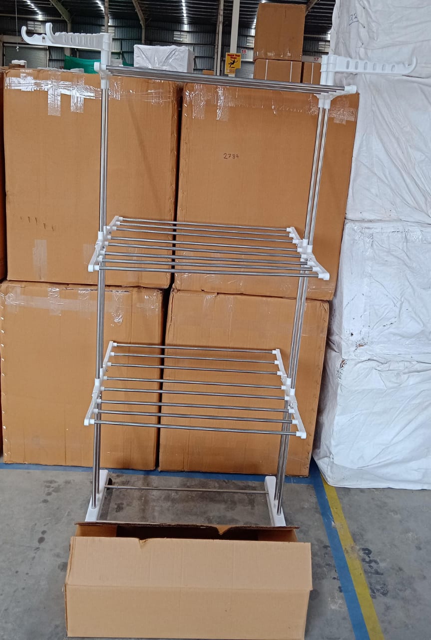 Lifestyle image of the cloth drying stand in a bright, airy laundry space.
