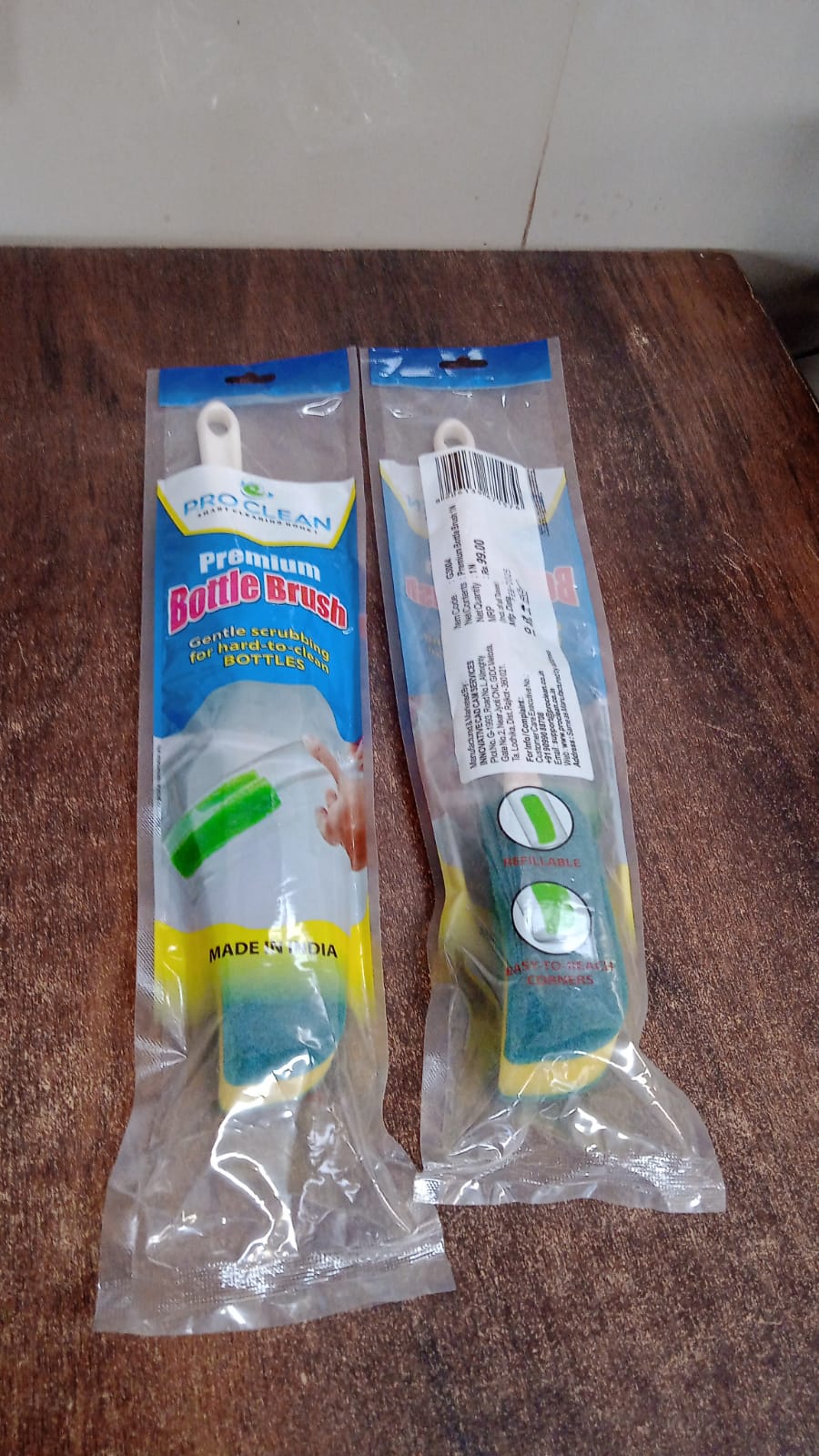 Angled view of bottle cleaning brush showing sponge and scrub pad head