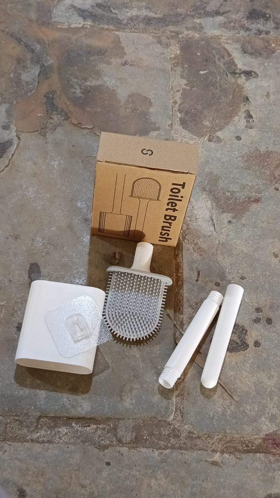 Complete portable toilet brush set with a wall hook accessory.