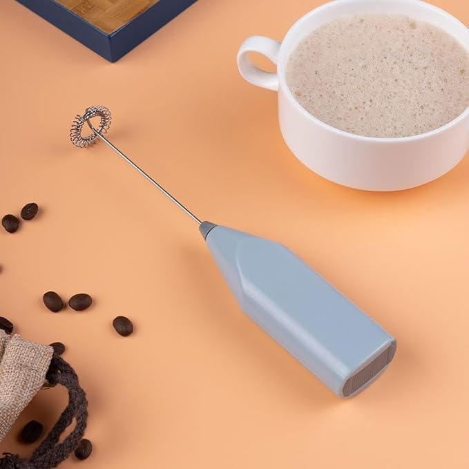Close-up of coffee milk frother machine blending coffee and milk