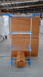 Metallic drying rack with wheels shown in folded position for storage