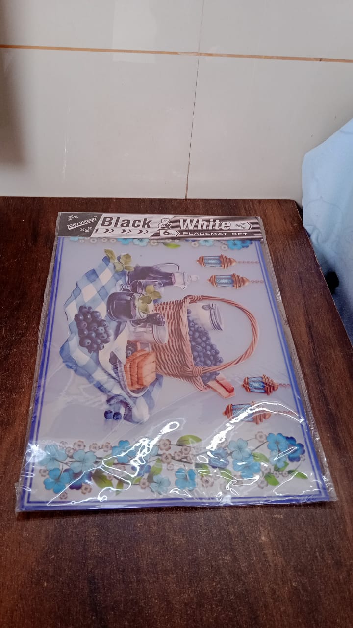 The complete set of 6 multicolor PVC dining table placemats, neatly packaged.