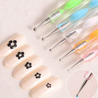 Textured grip on a nail art pen for better handling.