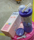 Portable smoothie maker powered on, with its blades visible and ready for use.