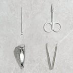 The AuriGlam 4-piece stainless steel nail clipper set displayed in its open case.