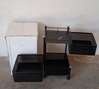Fully assembled 3-layer metal kitchen trolley with wheels in a modern kitchen setting.