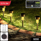 Outdoor solar pathway lamps with glowing LEDs in garden setting