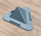 Grey pyramid mobile phone stand placed on office desk