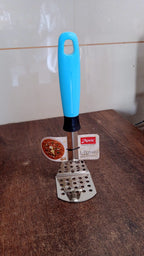 Stainless steel potato masher placed on kitchen counter