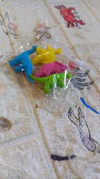 A complete set of four non-toxic dinosaur erasers, essential fun stationery for kids.