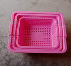 Plastic baskets for fruit, displayed neatly in a kitchen setting.
