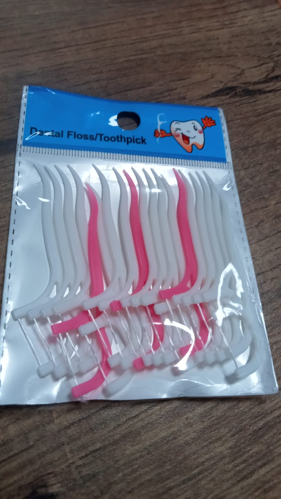 White dental floss picks with a textured grip.