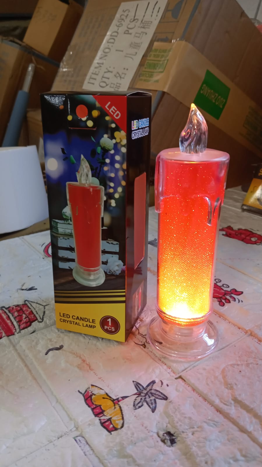 Close-up of the red LED candle, emphasizing its realistic flame-like appearance and safety features.
