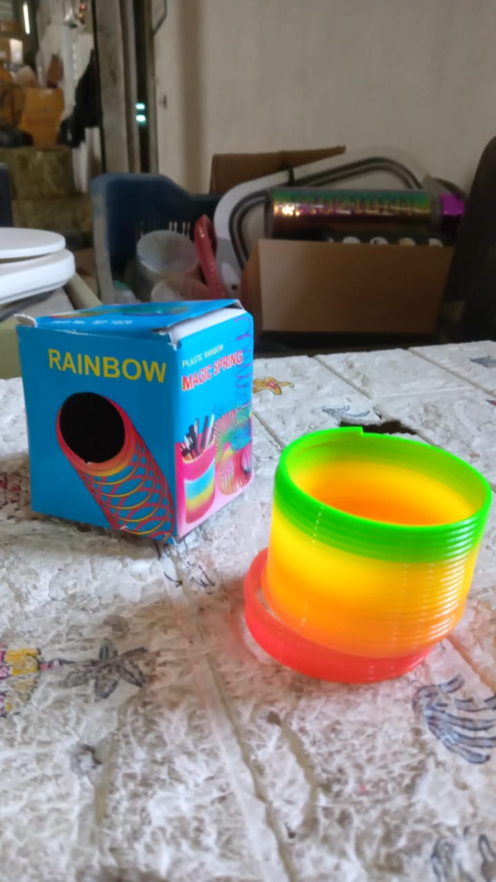 The Rainbow Slinky Toy neatly packaged, ready to be presented as a delightful gift.