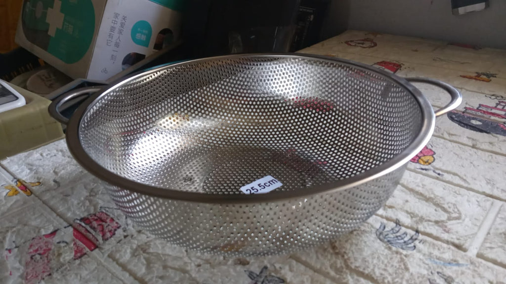 Angled shot of the versatile kitchen colander, ready for use.