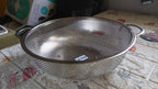 Angled shot of the versatile kitchen colander, ready for use.