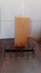 Space-saving cup holder rack mounted under kitchen cabinet showing organized mugs.