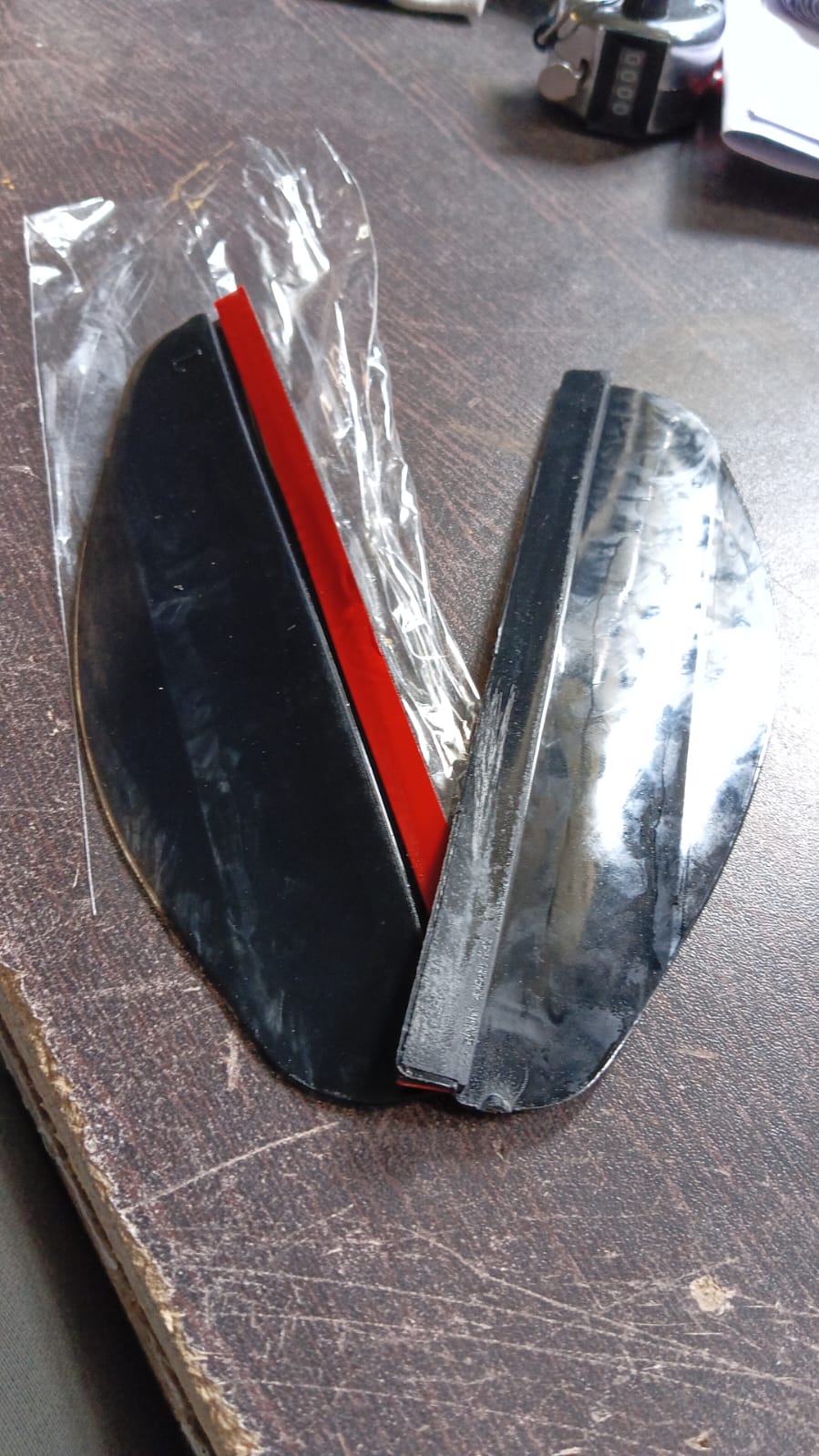 Packaging and components of the easy-to-install car mirror rain protector set.