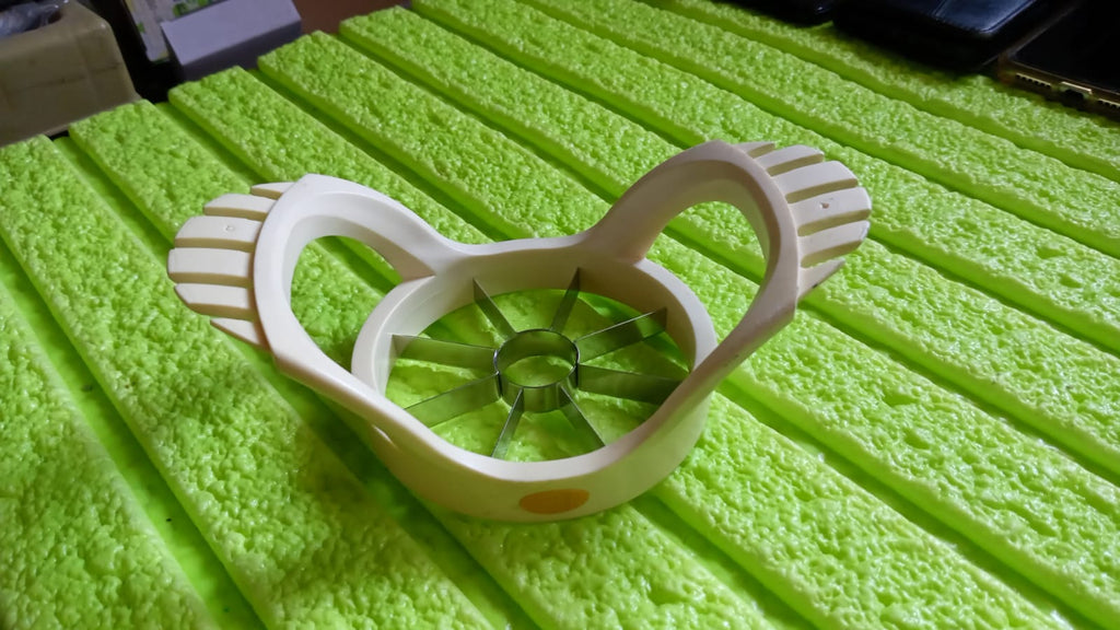 Side view of the compact stainless steel apple slicer, highlighting its efficient design.