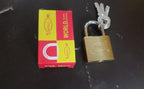 Angle view of a strong brass padlock, highlighting its solid construction.