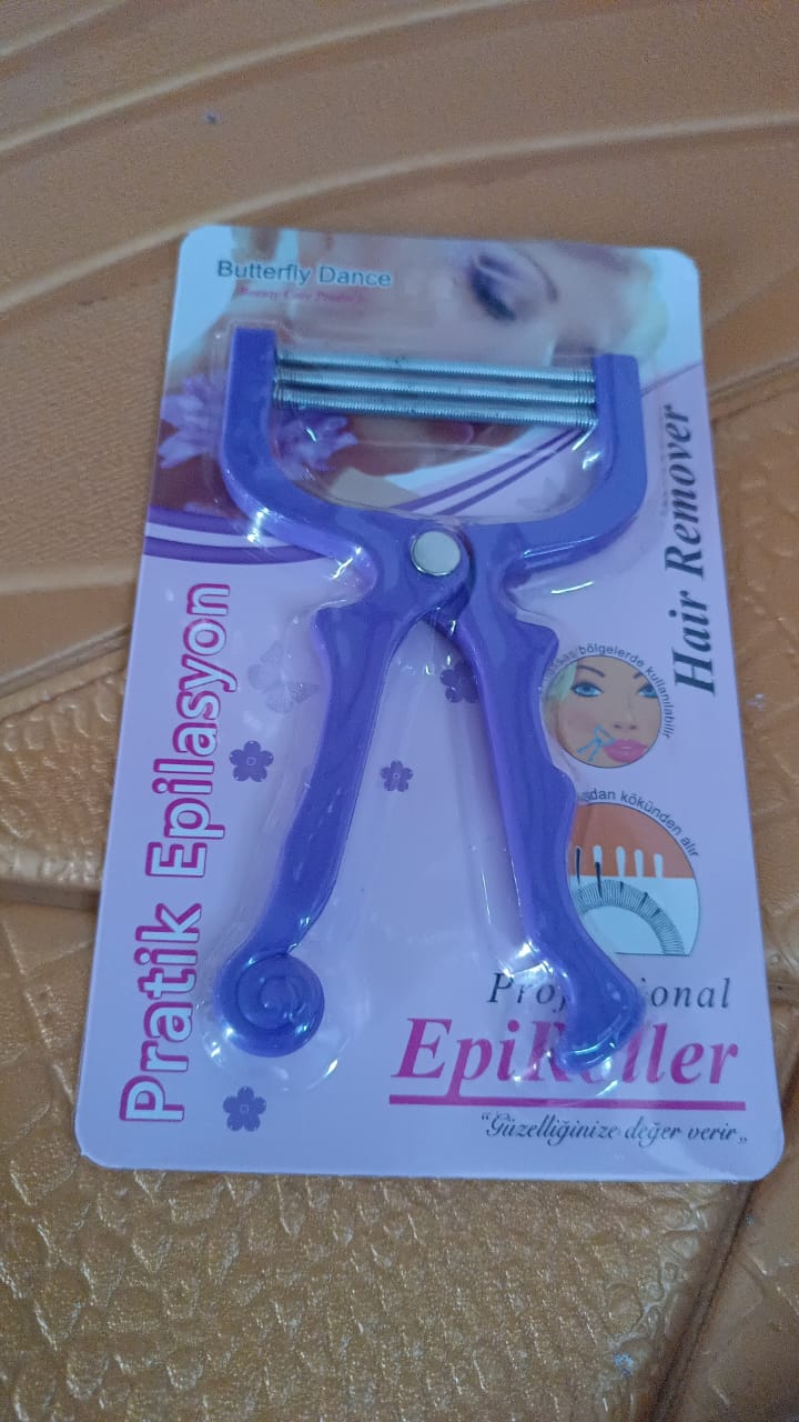 Manual facial hair remover threading tool held in hand for precision grooming