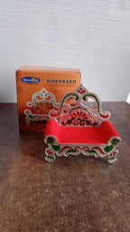 Side angle showing velvet cushioned seat on small plastic decorative singhasan