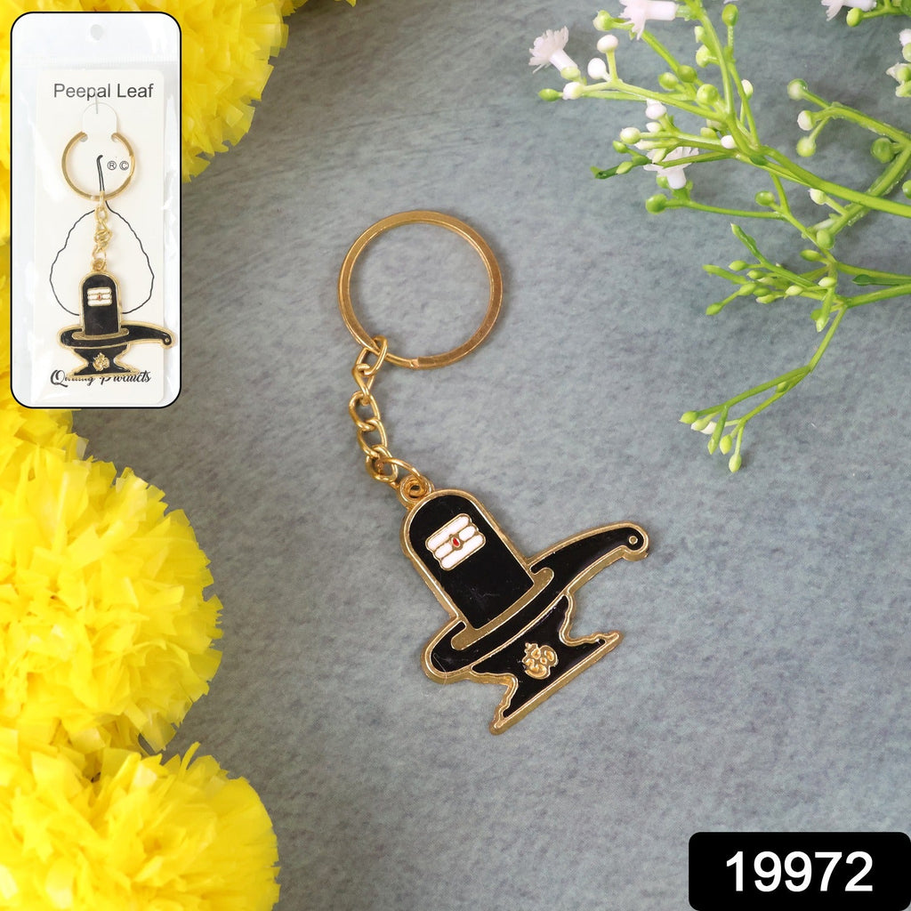 Close-up view of detailed Shivling design on golden metal keychain