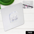 No-drill wall hook securely holding kitchen utensils on a tiled kitchen wall.