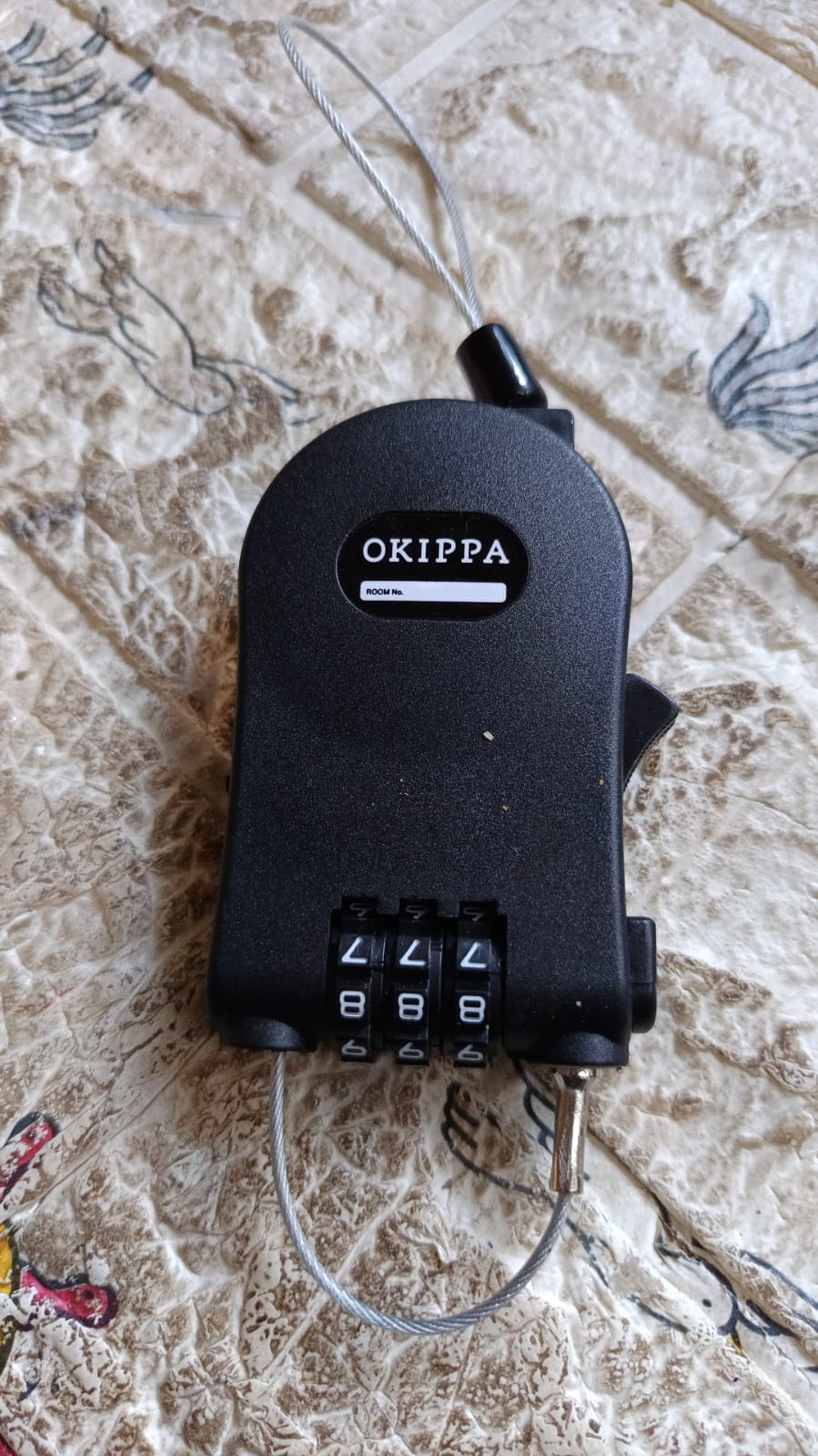 Detailed view of the three-dial combination mechanism on the secure travel lock.