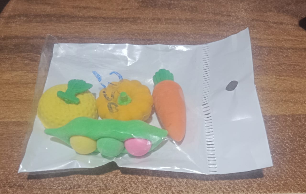 Playful display of vibrant erasers on a clean white surface.