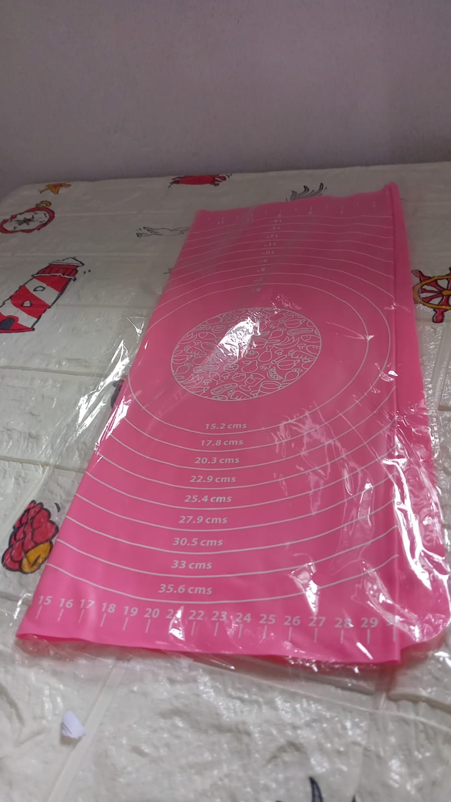 Hands rolling dough on the silicone baking mat, utilizing its non-stick property and guides.