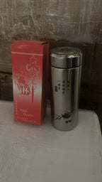 A hand holding the portable 380ml Mini Stainless Steel Water Bottle, ready for use.
