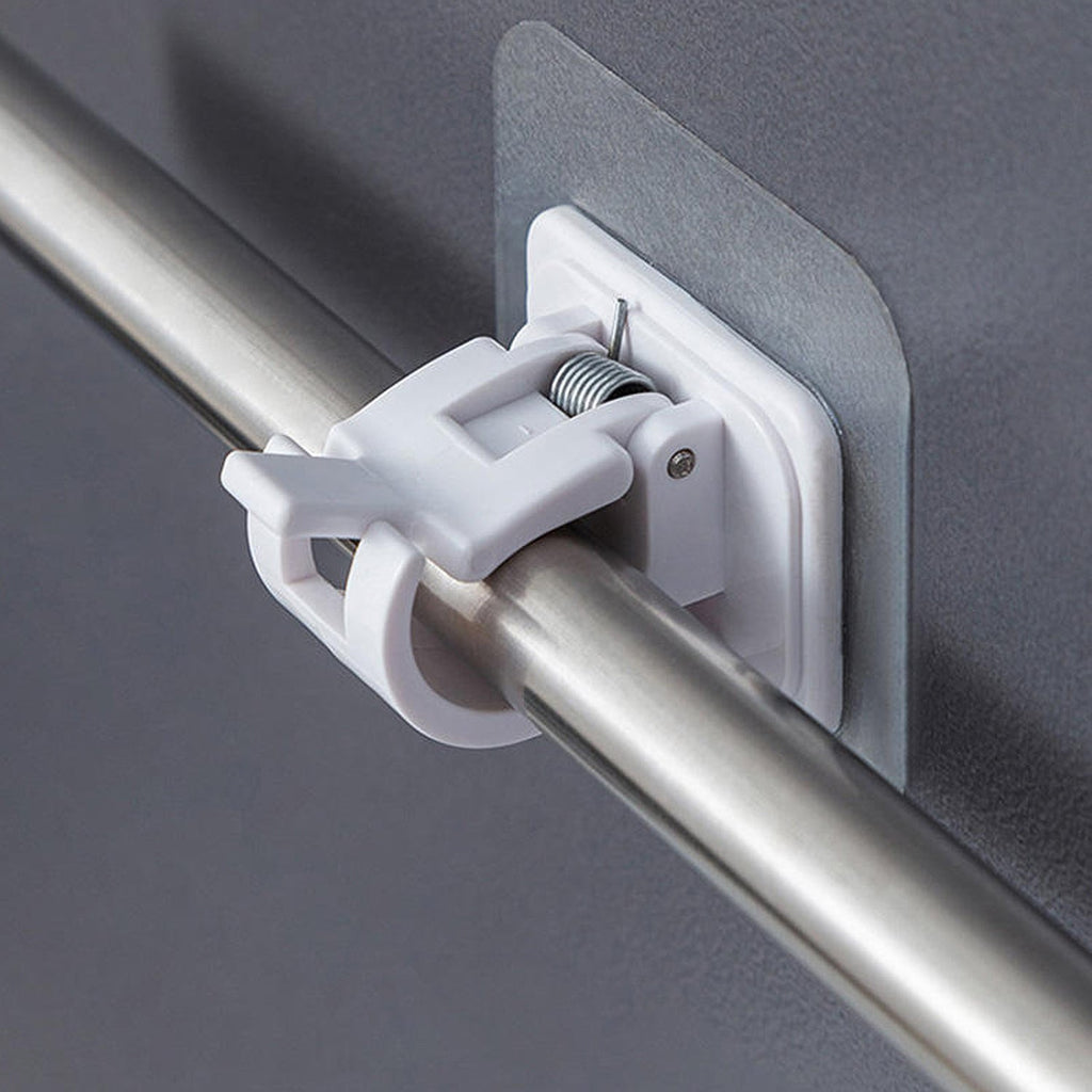 Close-up of wall-mounted adhesive towel rod holder with hanging towels