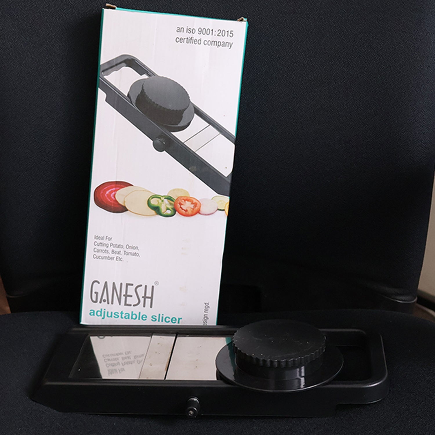Kitchen mandoline slicer showing adjustable thickness knob on side
