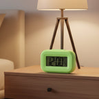 Close-up product image of digital alarm clock with date and temperature
