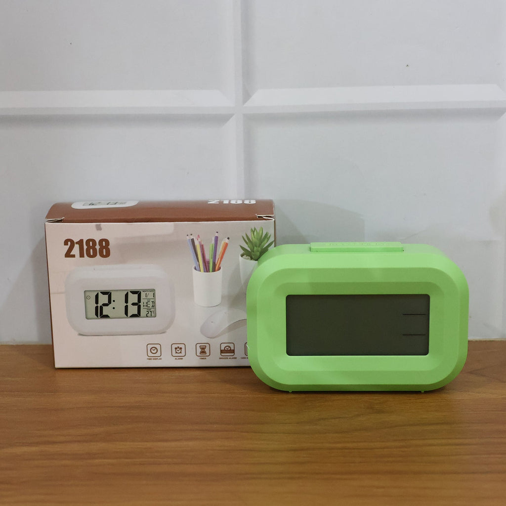 Lifestyle image of digital alarm clock on desk in office space