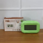 Lifestyle image of digital alarm clock on desk in office space