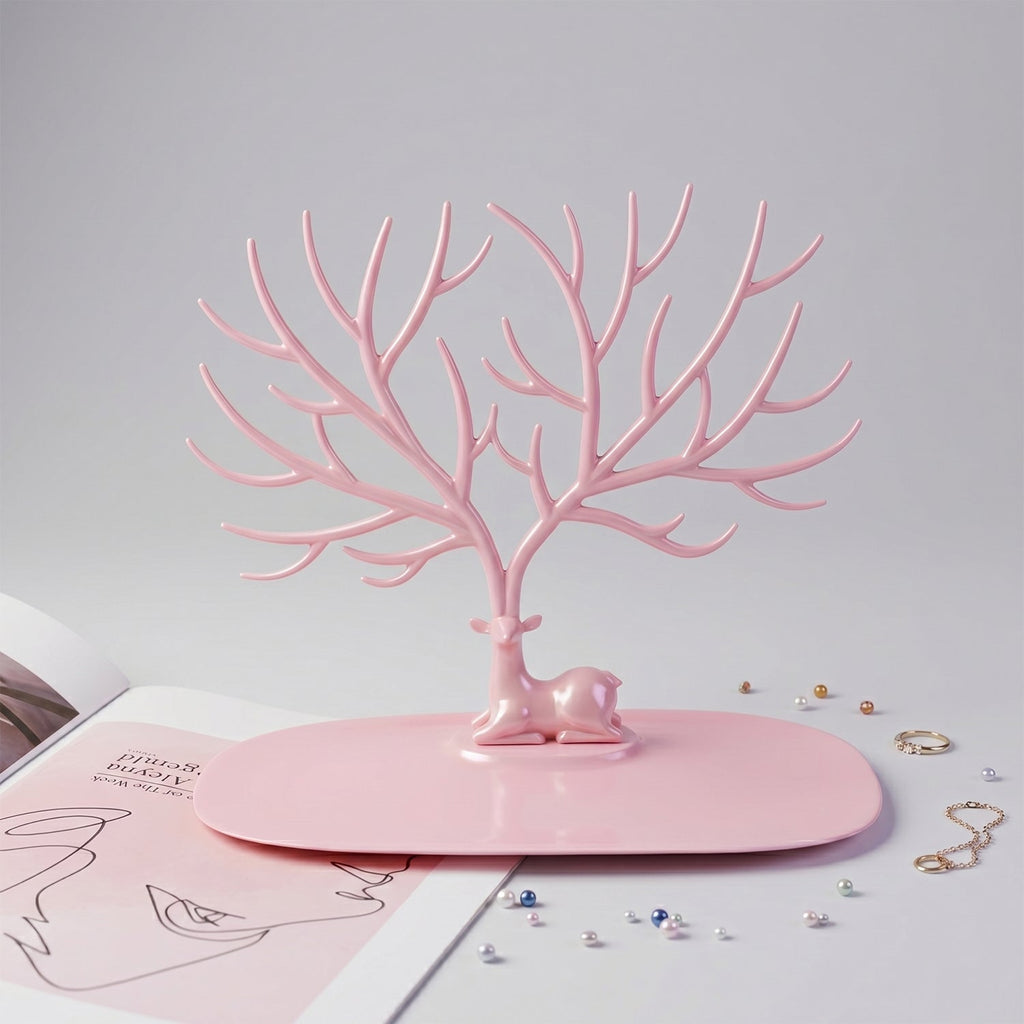 Front view of pink deer jewelry stand with earrings and rings, India