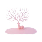 Top view of pink deer jewelry stand with branches for accessories, India